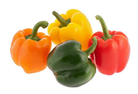 Orange, yellow, red and greeen bell peppers isolated on whiteの写真素材