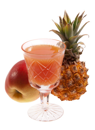 Glass of fruit juice, an apple and a pineapple isolated on whiteの写真素材