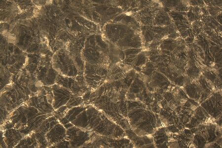 A background of sun and shadows on the ocean floorの写真素材