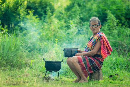 Grandfather radio cooking folk happily.の写真素材