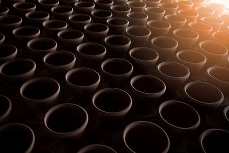 A narrow depth-of-field, blurred background and a large traditional indigenous pottery jar sits side-by-side in an Asian stone mortar pottery.の写真素材