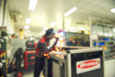 Blurred image of a welder working with electronics at a semi-automatic arc welding in an Asian production facility.の写真素材