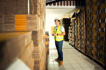Warehouse workers checking stock in a large warehouse in a large warehouse.の写真素材