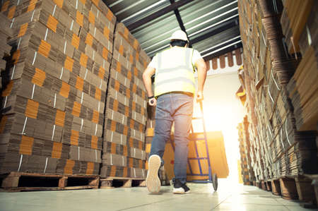 Warehouse workers checking stock in a large warehouse in a large warehouse.の写真素材