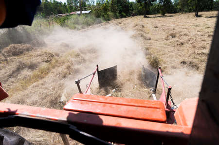 agricultural machinery Tractor with mower on a golden field Pangola hay harvesting ideas, hay, commercial Pangola hay farms.の写真素材
