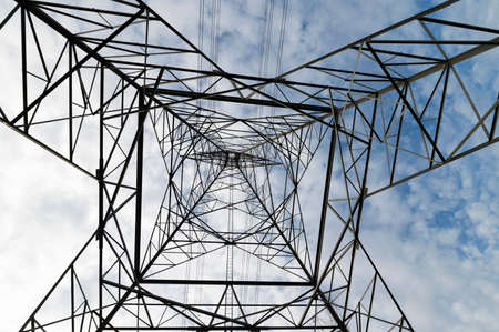 High voltage poles and power lines in power plants There is an area after sunset with electric power.の写真素材
