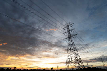 High voltage poles and power lines in power plants There is an area after sunset with electric...