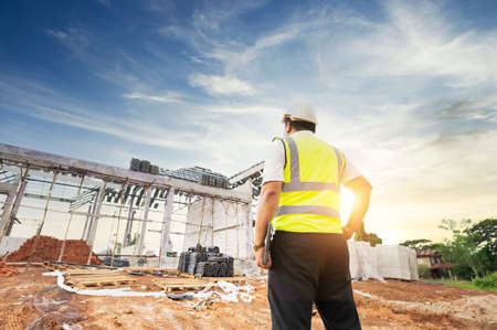 Engineers and architects supervise the construction of houses on residential construction sites.の写真素材