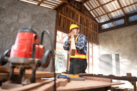 Carpenter working in an Asian carpentry office working portrait of a white man.の写真素材