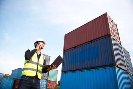 Foreman controls the loading of containers from cargo ships for import and export,Foreman or Supervisor in Container Terminal.の写真素材