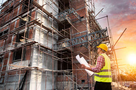 Construction engineers use radios to control work at construction sites. industrial workers wearing helmetsの写真素材