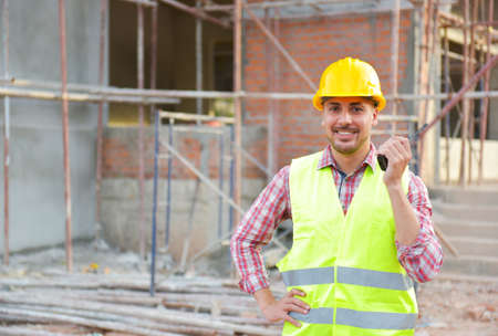 Construction engineers use radios to control work at construction sites. industrial workers wearing helmetsの写真素材