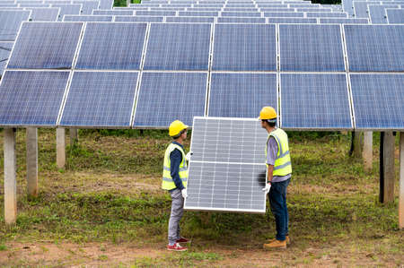 A team of male engineers is about to install solar panels. at the solar power station Engineer team...