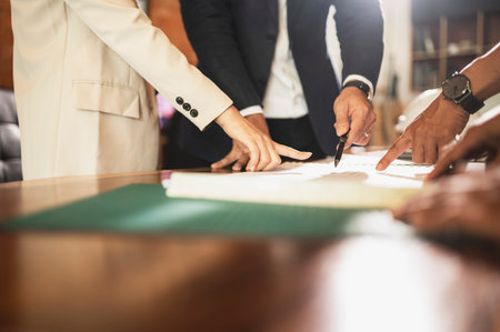 Construction analysts talk in a conference room, analysts work as a team meeting to solve problems and discuss construction projects. real estate in the near termの写真素材