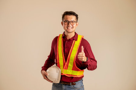 Portrait of an Asian engineer studying a room plan civil engineer at construction site