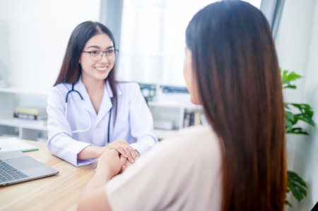 Asian young woman suffering from flu visiting professional doctor for sick problem consultation in clinic officeの写真素材