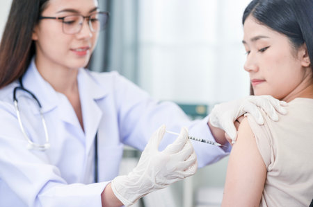 Doctor doing vaccination on patient's shoulder, influenza vaccination on arm