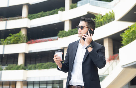 Asian young businessman Searching for information on internet with smartphone. Business, education, lifestyle concept.の写真素材