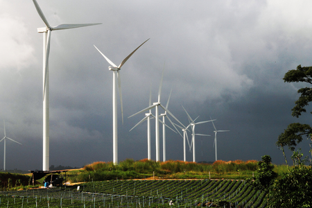 Wide field and wind turbine for electric and the rain is falling at Thailandの写真素材