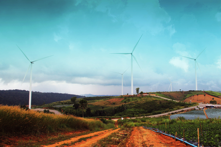 Wide field and wind turbine for electric in evening at Thailandの写真素材