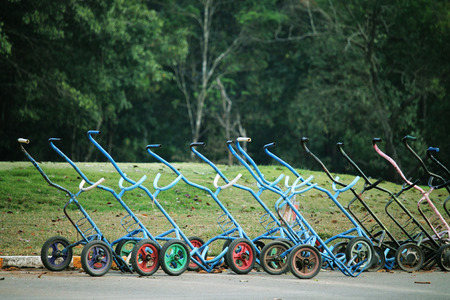 Golf trolley in evening golf course has sunlight shining down at golf course in Thailandの写真素材