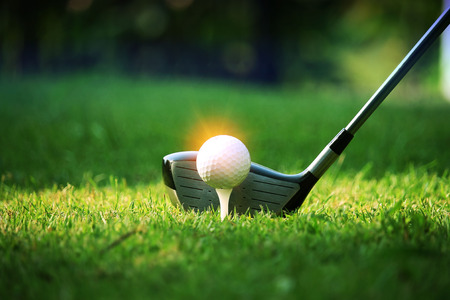 golf club and golf ball close up in grass field with sunset. Golf ball close up in golf coures at Thailandの写真素材