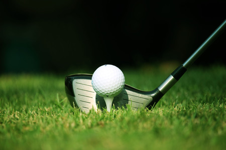 golf club and golf ball close up in grass field with sunset. Golf ball close up in golf coures at Thailandの写真素材