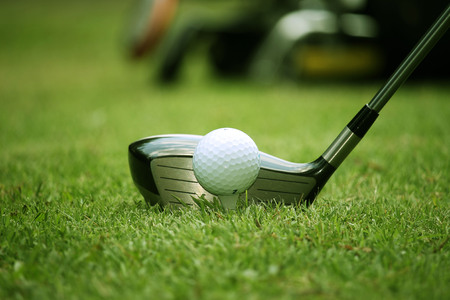 golf club and golf ball close up in grass field with sunset. Golf ball close up in golf coures at Thailandの写真素材