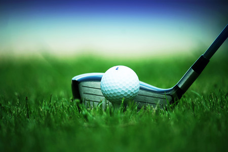 golf club and golf ball close up in grass field with sunset. Golf ball close up in golf coures at Thailandの写真素材