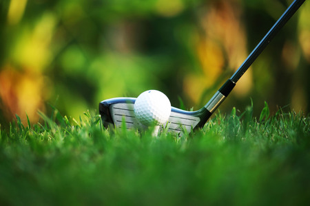 golf club and golf ball close up in grass field with sunset. Golf ball close up in golf coures at Thailandの写真素材