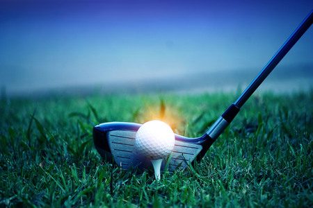 golf club and golf ball close up in grass field with sunset. Golf ball close up in golf coures at Thailandの写真素材