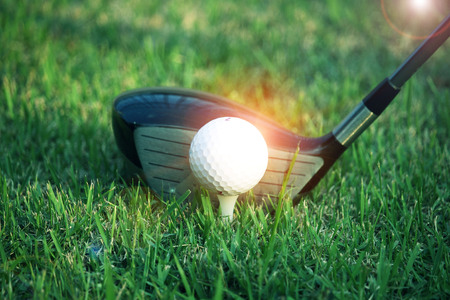 golf club and golf ball close up in grass field with sunset. Golf ball close up in golf coures at Thailandの写真素材
