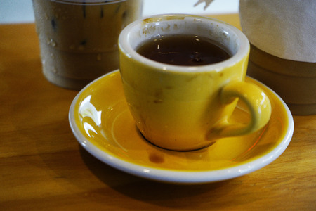 Ice coffee and hot coffee with milk on the wooden tableの写真素材