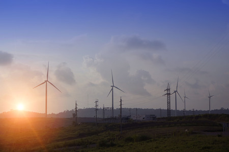 wind turbines on the mountain. wind turbine field and Rotary propeller moving at sunsetの写真素材