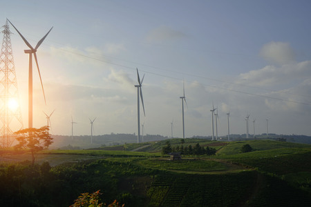 wind turbines on the mountain. wind turbine field and Rotary propeller moving at sunsetの写真素材