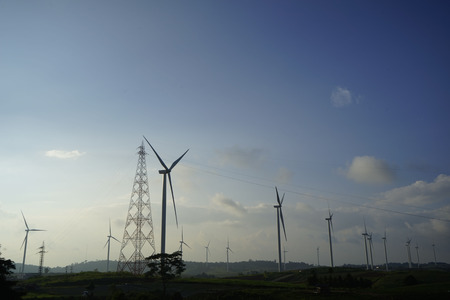wind turbines on the mountain. wind turbine field and Rotary propeller moving at sunsetの写真素材