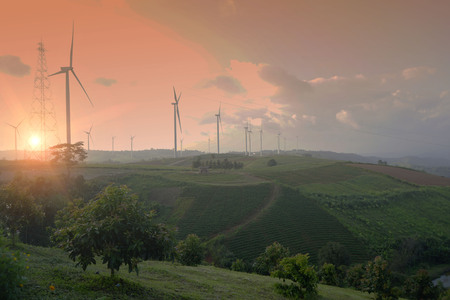 wind turbines on the mountain. wind turbine field and Rotary propeller moving at sunset