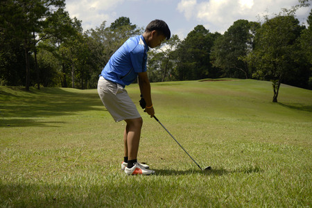 Golfer playing golf in beautiful golf course in the evening golf course with sunshine in thailandの写真素材