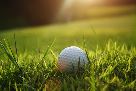 Blurred golf ball in beautiful golf course with sunset. Golf ball close up in golf coures at Thailandの写真素材
