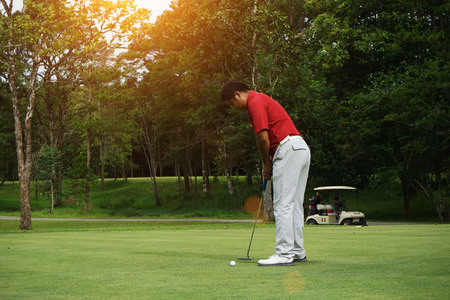 Blurred golfers are putting golf in the evening golf course golf backglound in Thailandの写真素材