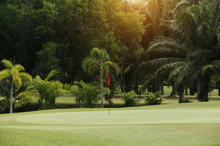 Background of evening golf course has sunlight shining down at golf course in Thailand
