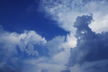 Beautiful blue sky with cloud. Color sky is clear with white clouds on natural background. White fluffy cloudy abstract background.                                 の写真素材