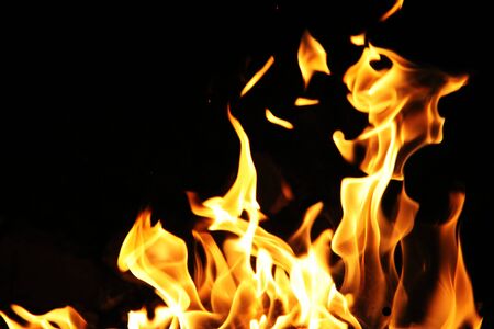 Blaze fire flame texture background. Fire flames on black backgroundの写真素材