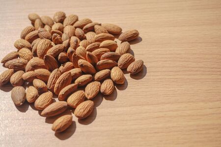 Almond nuts on wood background                               の写真素材