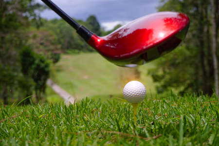 Blurred golfer playing golf in beautiful golf course in the evening golf course with sunshine in thailand.の写真素材