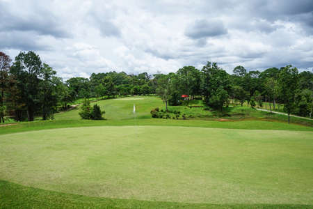 Beautiful golf course in a sunny day. Background evening golf course has sunlight shining down. Golf course in the countryside.の写真素材
