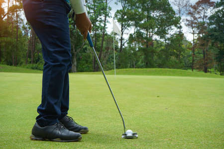 Blurred golf ball on green in the evening golf course with sunshine in thailand.の写真素材