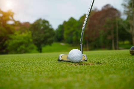 Blurred golf ball on green in the evening golf course with sunshine in thailand.の写真素材