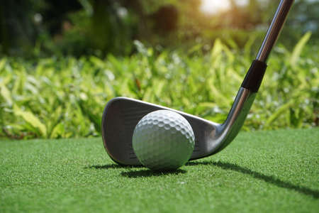 Golf balls on the golf course with golf clubs ready for golf in the first short. In the morning, with the beautiful sunlight.Sports that people around the world play in the holidays.の写真素材