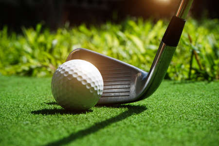 Golf balls on the golf course with golf clubs ready for golf in the first short. In the morning, with the beautiful sunlight.Sports that people around the world play in the holidays.の写真素材